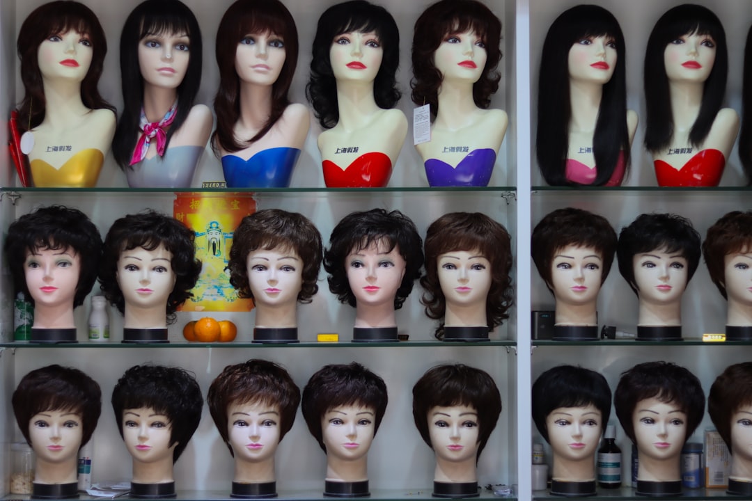 a-display-case-filled-with-lots-of-mannequin-heads-2zoqgjbgrqi